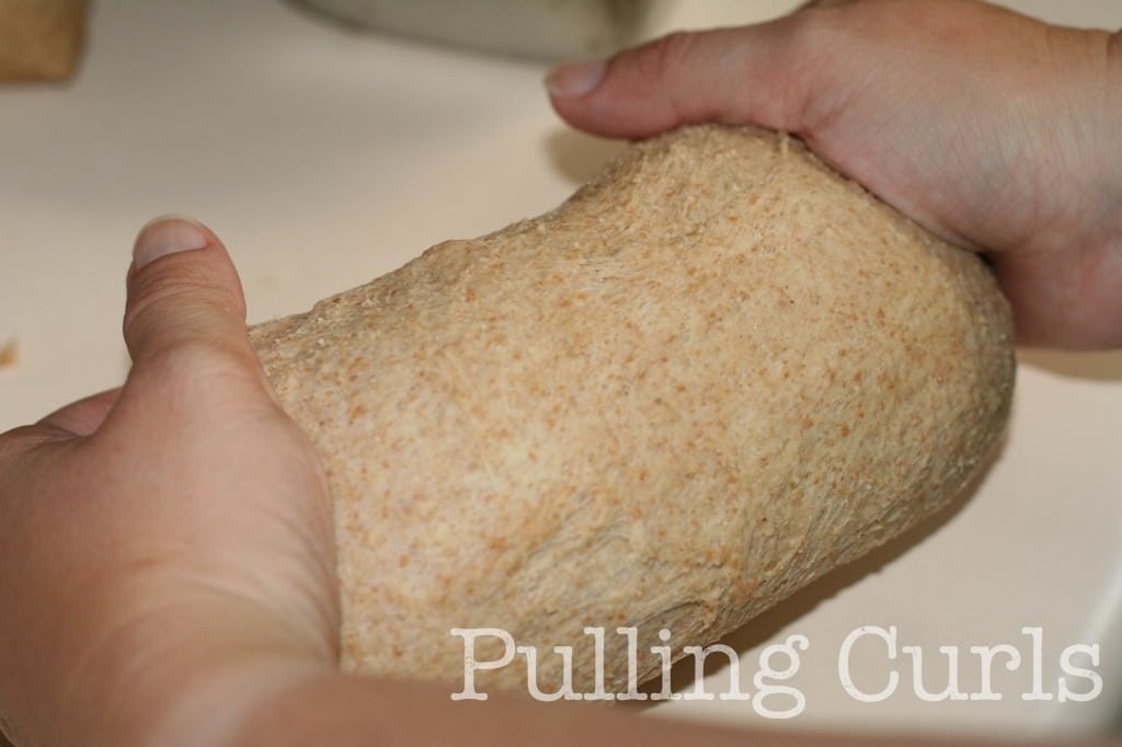 How to make bread loaves -- tuck the bottom under to make a smooth top.
