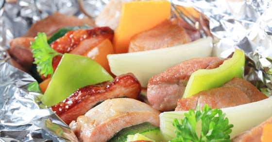 Pork and vegetable skewers in aluminum foil