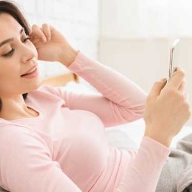 Woman listening to audiobook on phone