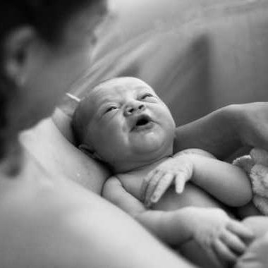 black and white photo of mom holding newborn baby