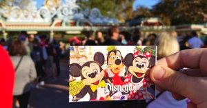 Disneyland Ticket being held in front of the Disneyland entrance