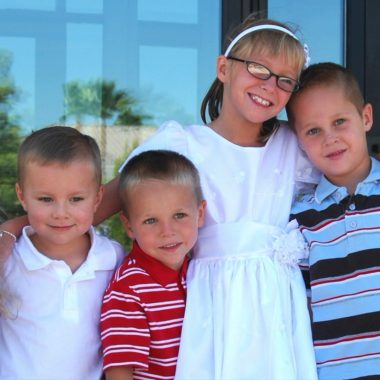 Girl with family/friends at Mormon baptism.