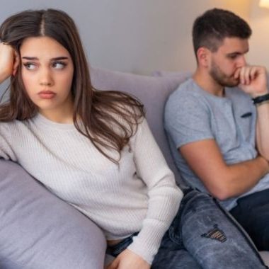 woman looking annoyed with man thinking in background