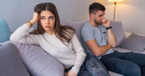 woman looking annoyed with man thinking in background