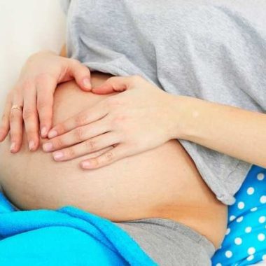 pregnant woman feeling belly