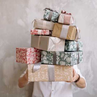 teen boy holding a bunch of gifts