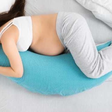 pregnant woman sleeping with body pillow