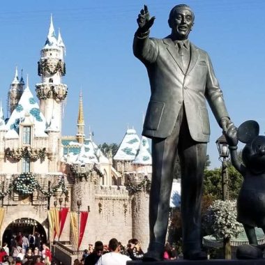 Walt Disney and Mickey Mouse statue in front of Sleeping Beauty Castle in Disneyland