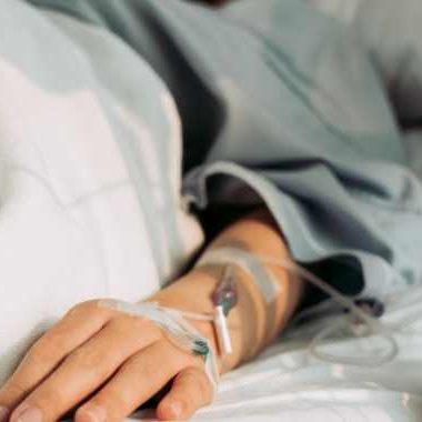 Woman laying in hospital bed with IV