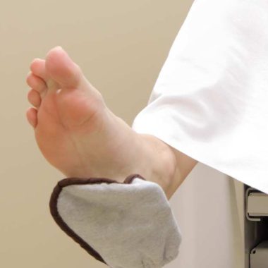 woman with foot in GYN stirrup