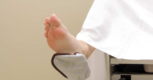 woman with foot in GYN stirrup