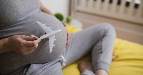 pregnant woman with plane on belly.