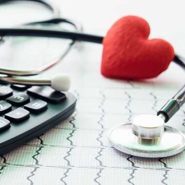 calculator, stethoscope and heart