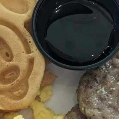 Mickey waffle, egg, syrup and sausage