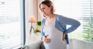 Pregnant woman holding her belly