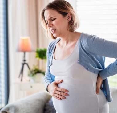 Pregnant woman holding her belly