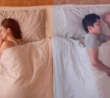 man and woman sleeping in bed