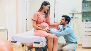 Pregnant woman at the hospital looking lovingly at husband