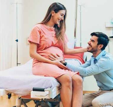 Pregnant woman at the hospital looking lovingly at husband